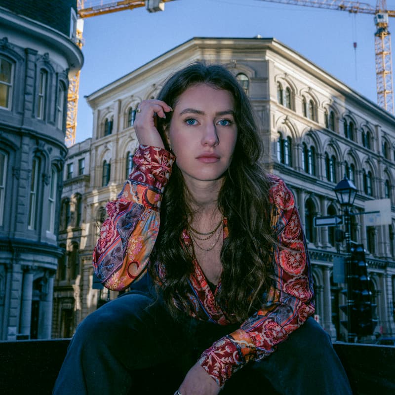 Final edited image of a girl in a city street using Kodak Portra Look Lightroom preset, with soft vintage tones and film-style warmth